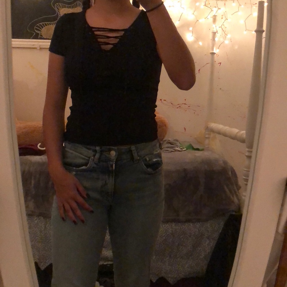 Black tee. Crosses at top.